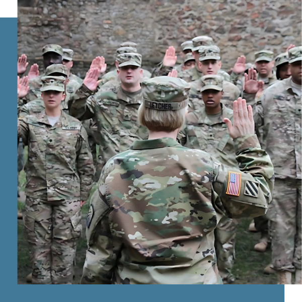 Michelle Letcher raises her right hand in front of a battalion.