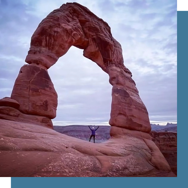 Michelle Letcher cheers from beneath a giant rock formation